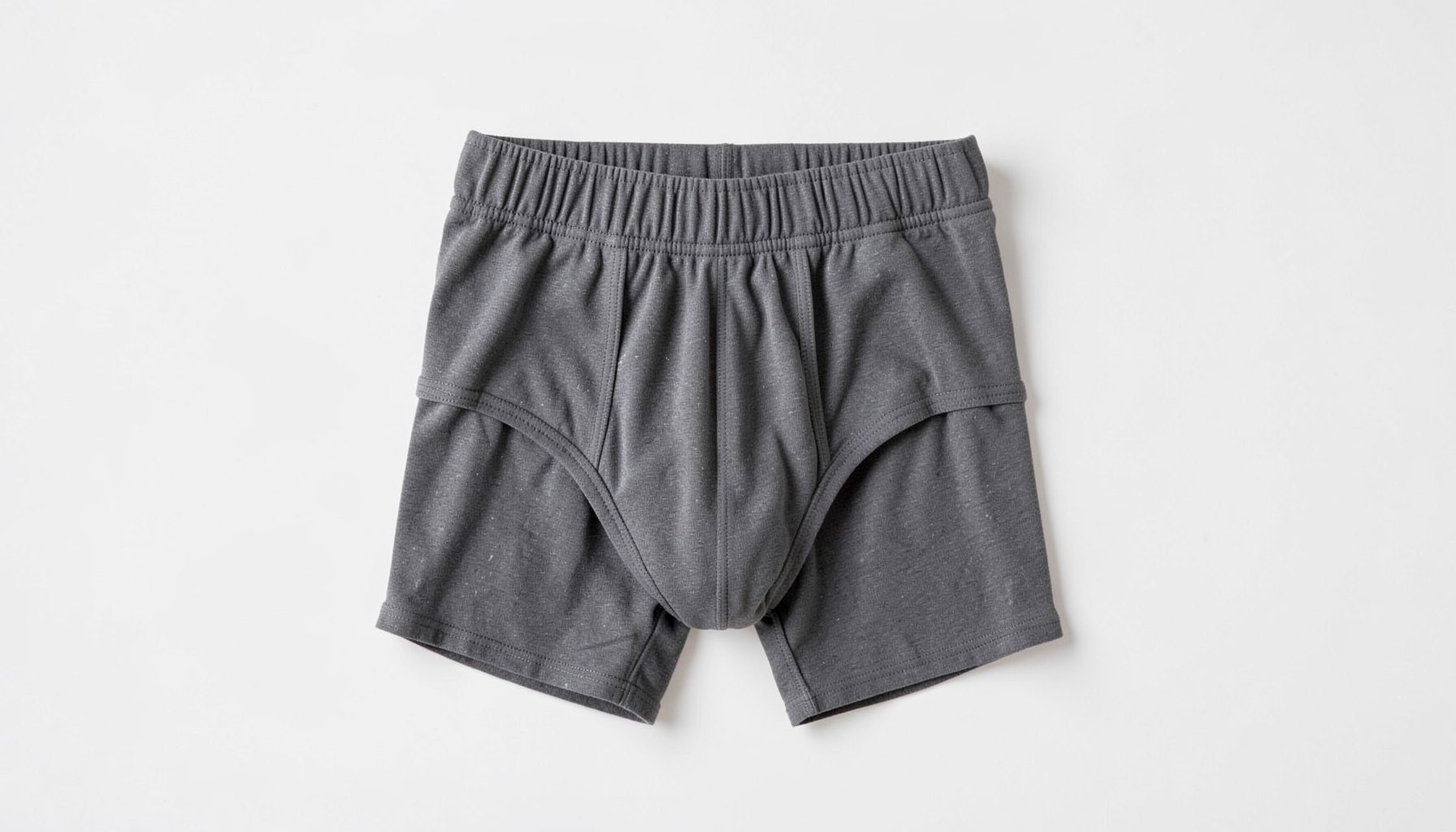 Men's shaping briefs in charcoal with an elastic waistband, photographed on a minimalist background