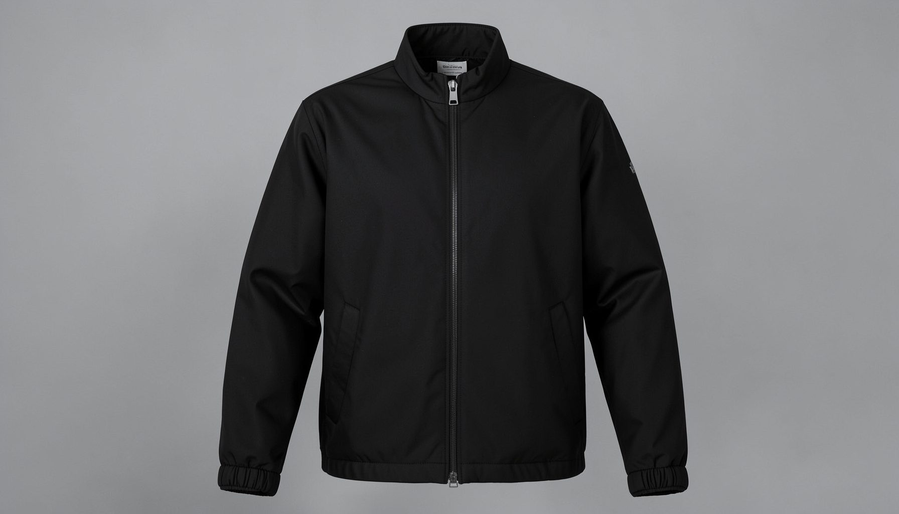 Men's sauna suit jacket in matte black with a full-zip front against a neutral gray backdrop